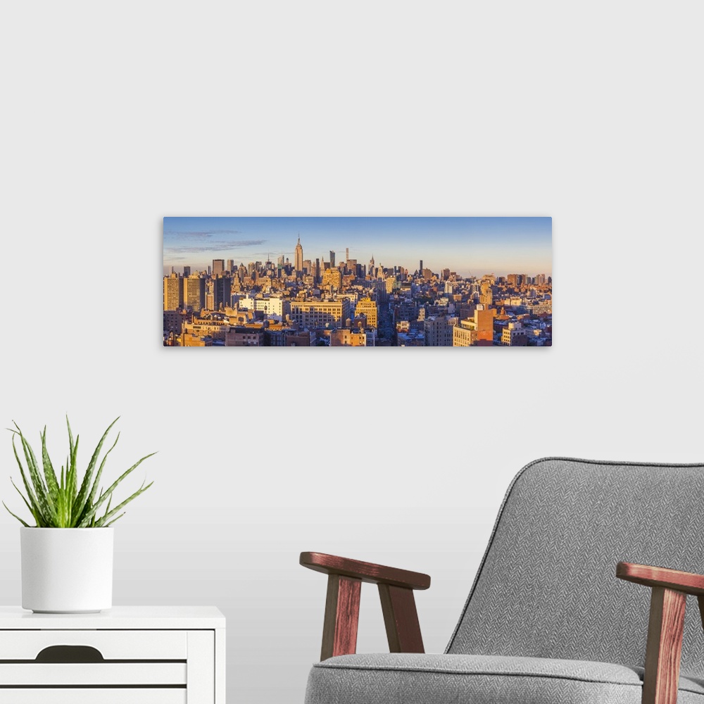 A modern room featuring USA, New York, New York City, Lower Manhattan, Mid-town Manhattan skyline, elevated view, sunset