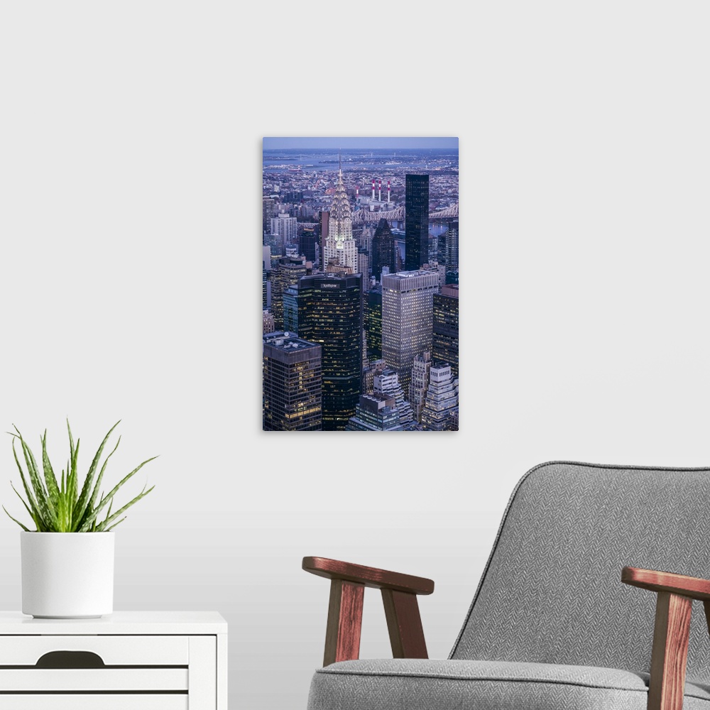 A modern room featuring USA, New York, New York City, Mid-Town Manhattan, elevated view towards Chrysler Building, dusk