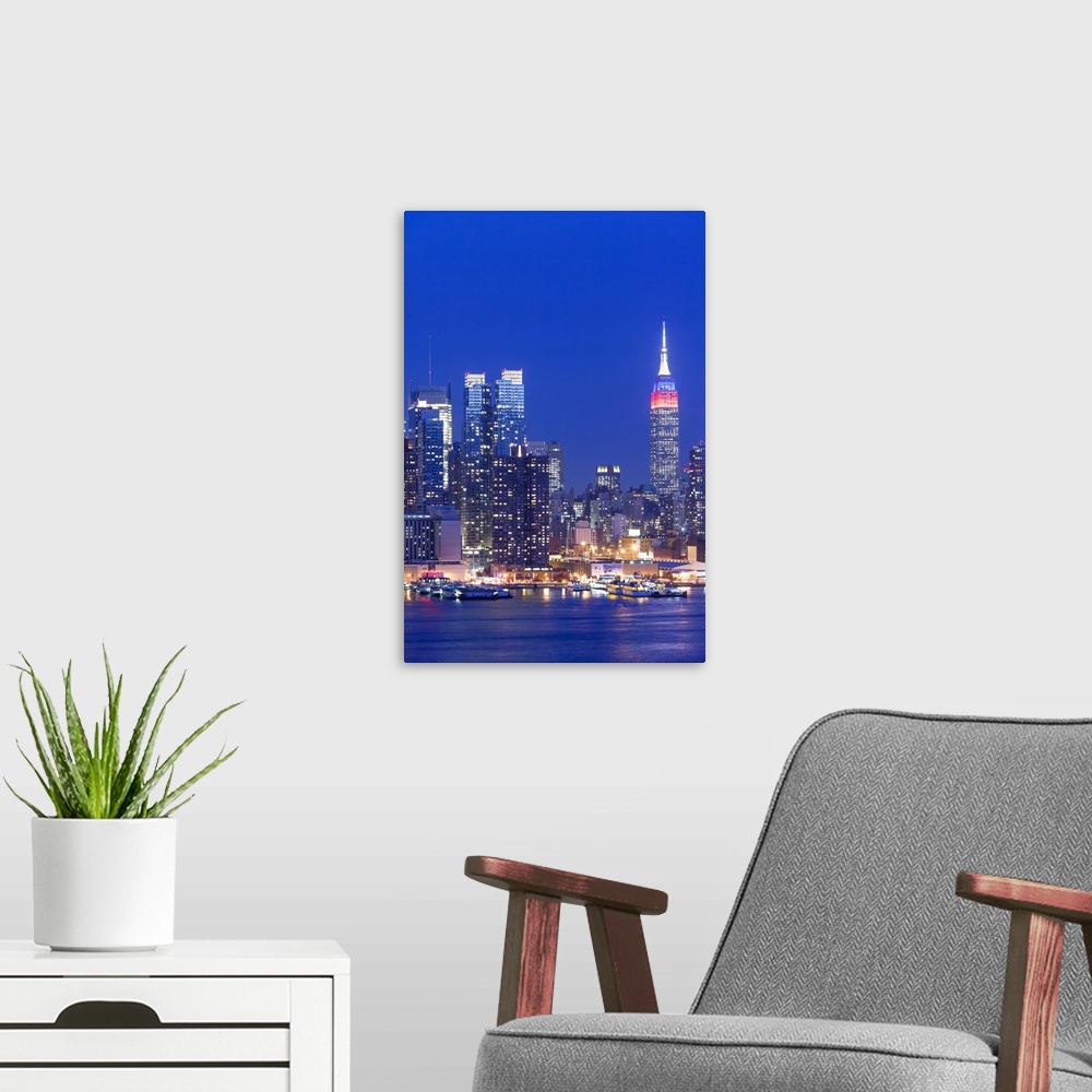 A modern room featuring USA, New York, New York City, elevated view of midtown Manhattan fand Empire State Building from ...