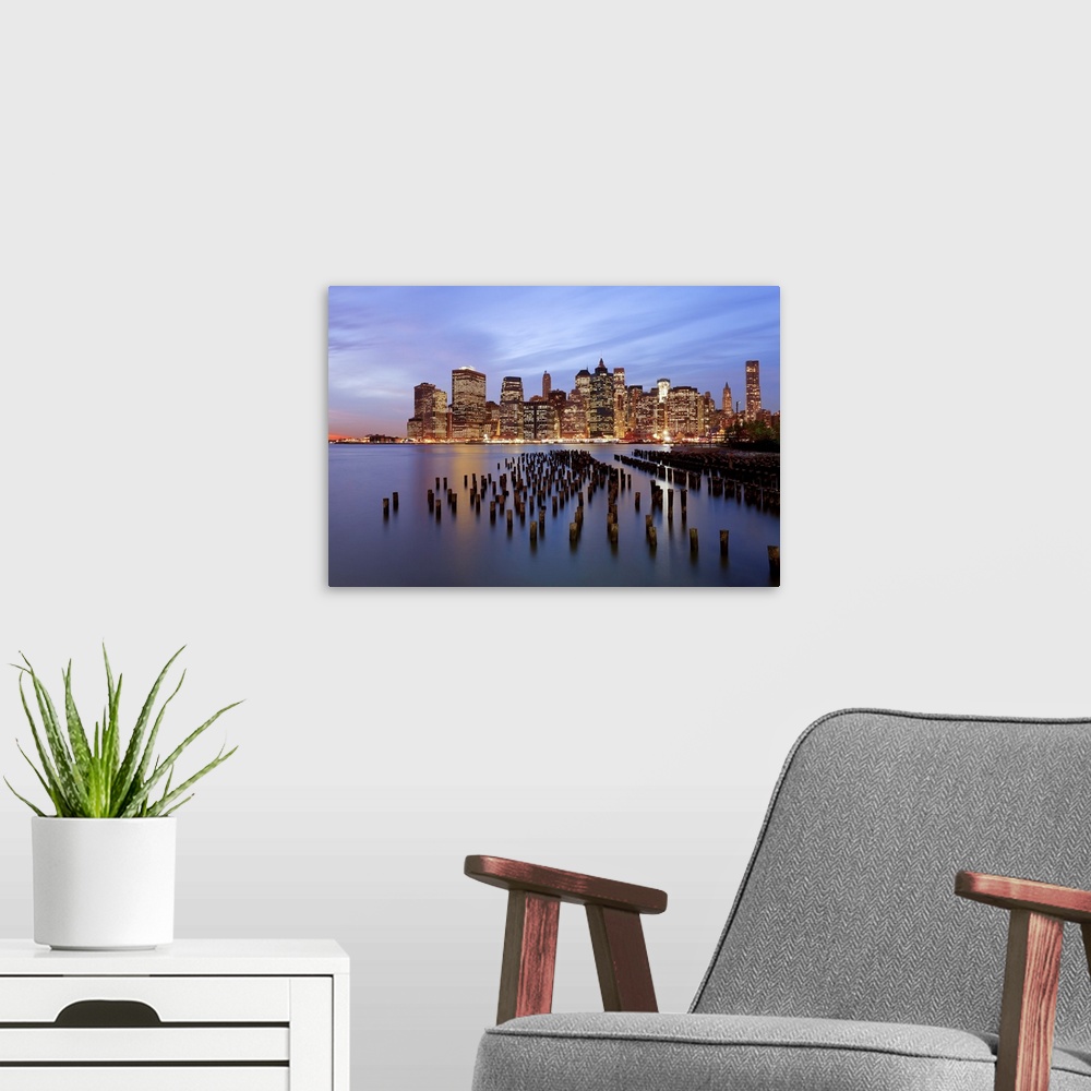 A modern room featuring United States of America, New York, Dusk view of the skyscrapers of Manhattan from the Brooklyn H...