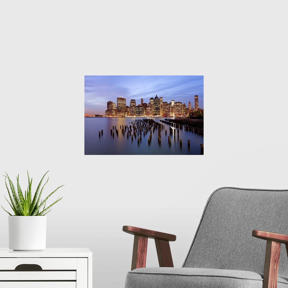 A modern room featuring United States of America, New York, Dusk view of the skyscrapers of Manhattan from the Brooklyn H...