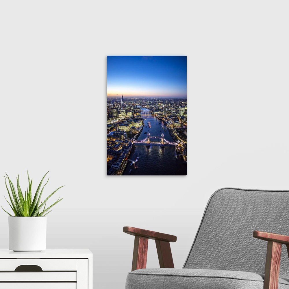 A modern room featuring Night aerial view of The Shard, River Thames, Tower Bridge and City of London, England