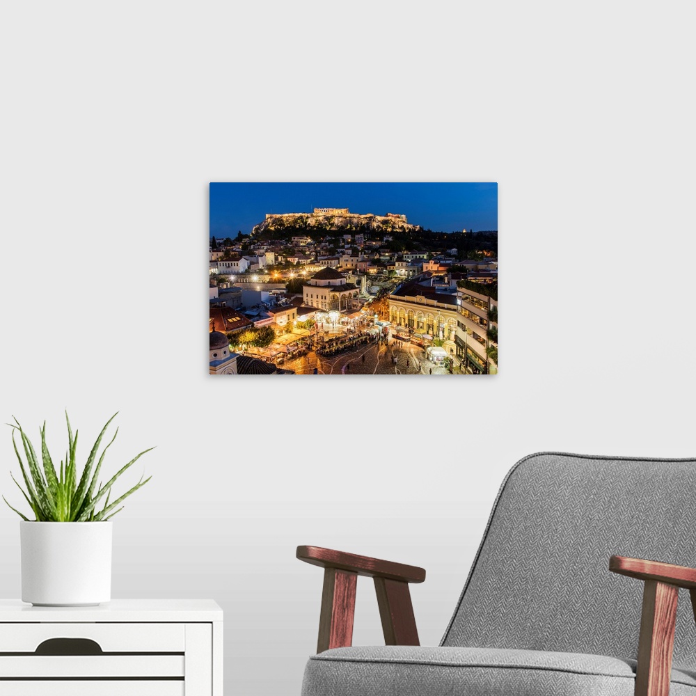 A modern room featuring Night city skyline with Monastiraki square and Acropolis in the background, Athens, Attica, Greece