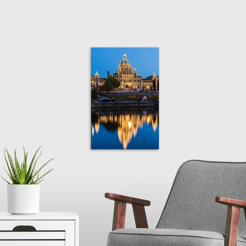 A modern room featuring Night view of the British Columbia Parliament Buildings, Victoria, British Columbia, Canada.