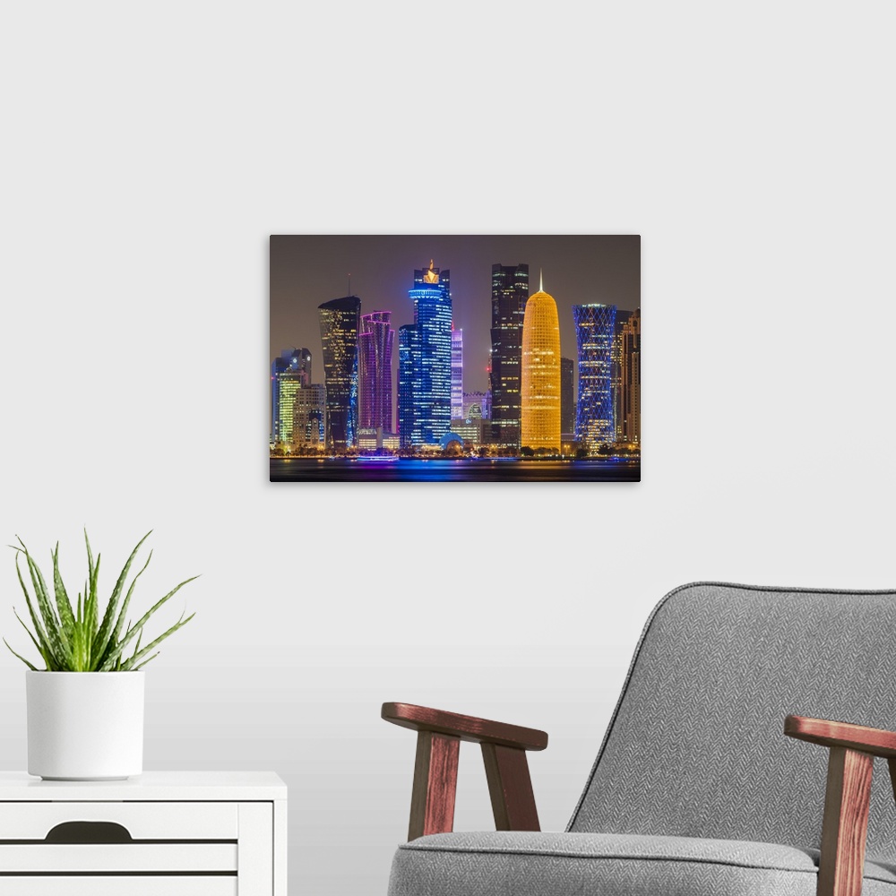 A modern room featuring Night view of the business district skyline, Doha, Qatar.