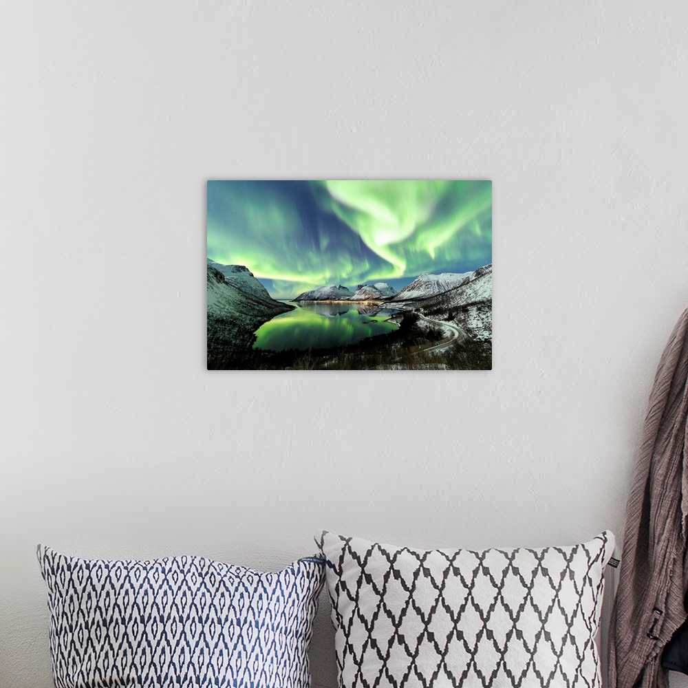 A bohemian room featuring Northern lights and stars light up the snowy peaks reflected in the cold sea Bergsbotn Senja Trom...