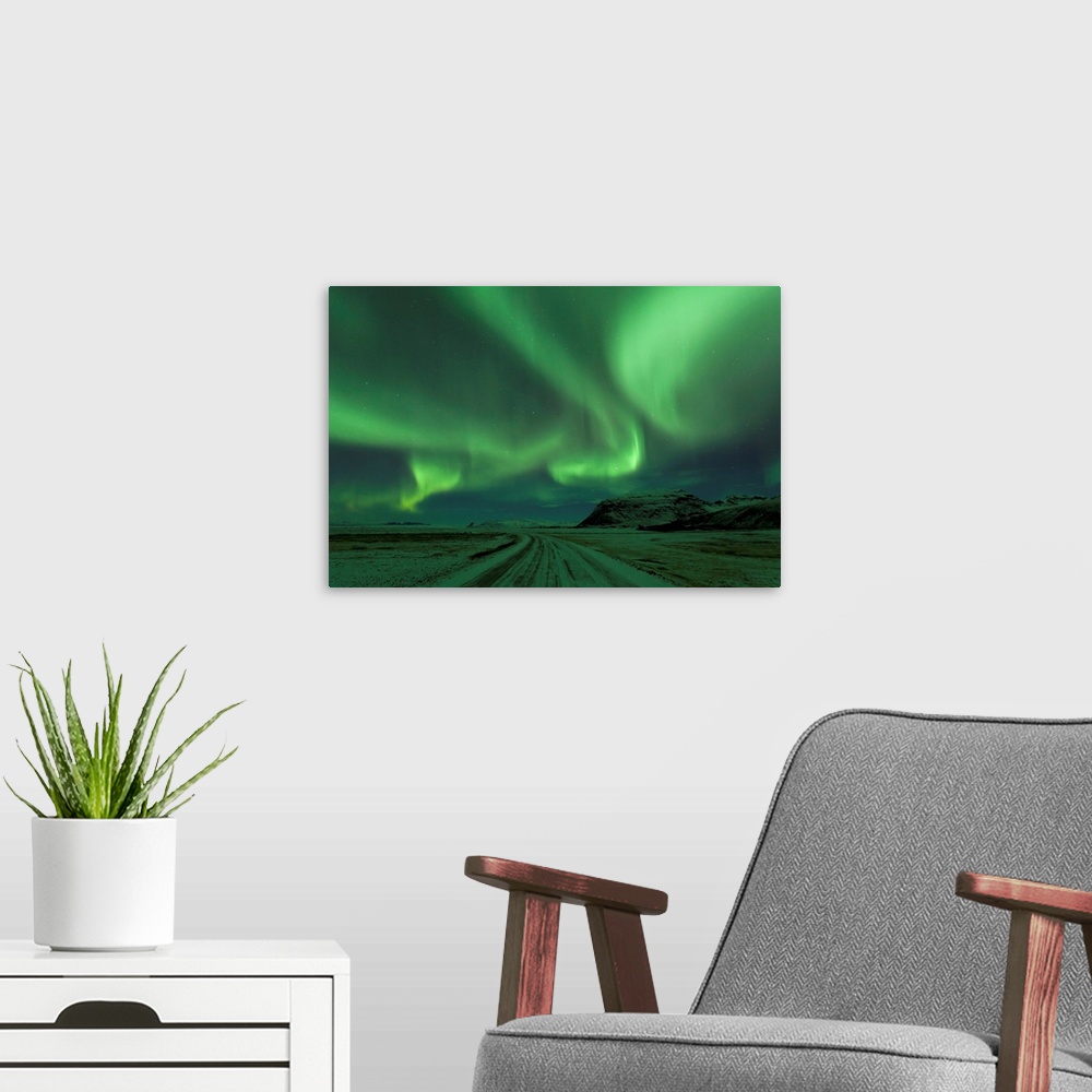 A modern room featuring Northern Lights, Aurora Borealis, Winter road with snow, Iceland