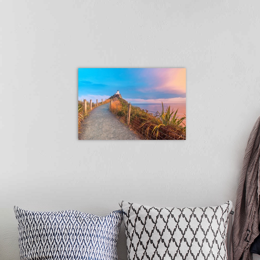 A bohemian room featuring Nugget Point lighthouse at sunset. Ahuriri Flat, Clutha district, Otago region, South Island, New...