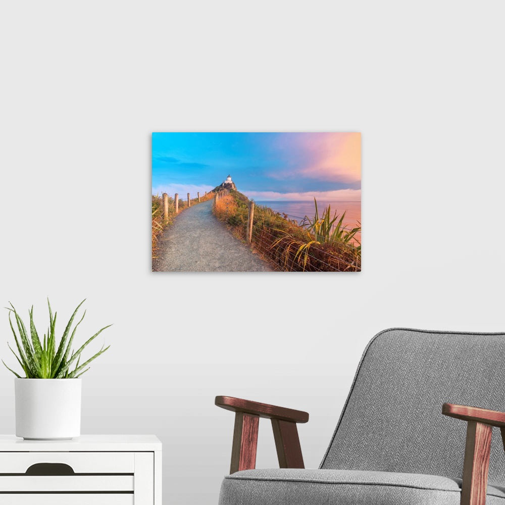 A modern room featuring Nugget Point lighthouse at sunset. Ahuriri Flat, Clutha district, Otago region, South Island, New...