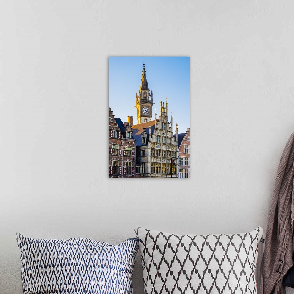 A bohemian room featuring Belgium, Flanders, Ghent (Gent). Old Post Office clock tower and medieval guild houses on Graslei.