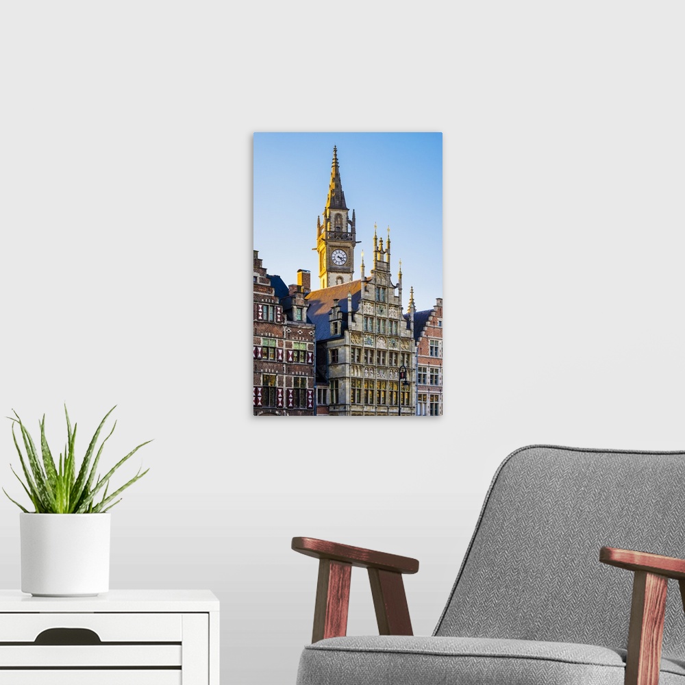 A modern room featuring Belgium, Flanders, Ghent (Gent). Old Post Office clock tower and medieval guild houses on Graslei.