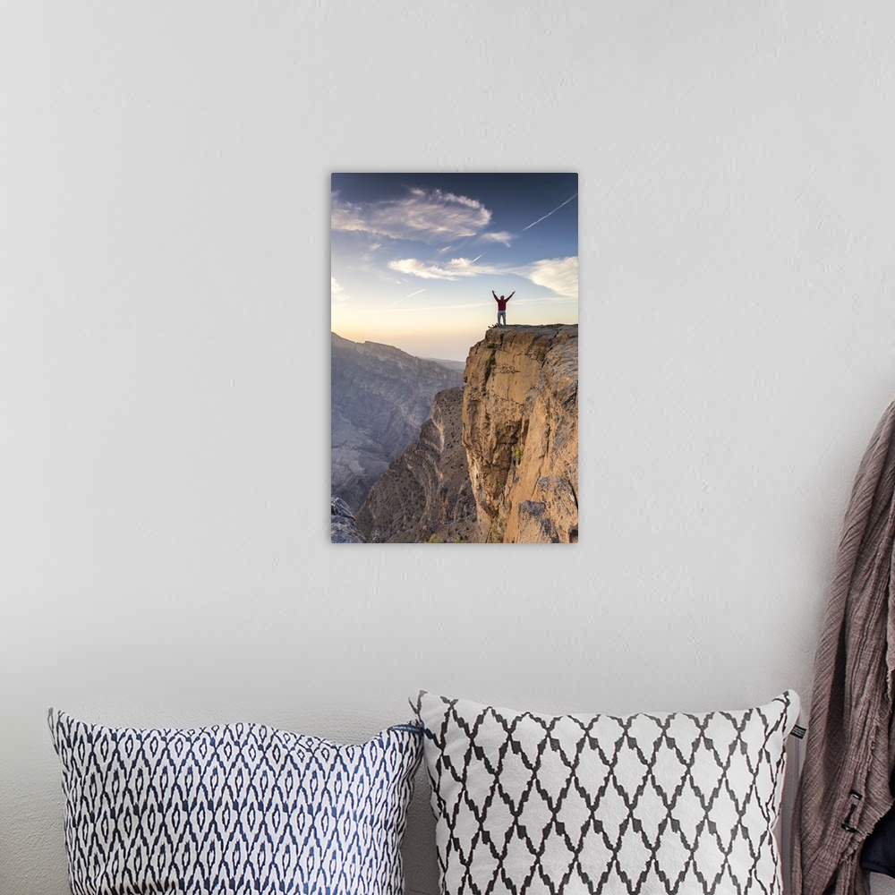 A bohemian room featuring Oman, Wadi Ghul, Jebel Shams. The Grand canyon of Oman, tourist on the edge looking at view, at s...