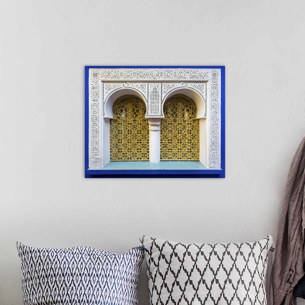 A bohemian room featuring Morocco, Marrakech-Safi (Marrakesh-Tensift-El Haouz) region, Marrakesh. Ornate window against blu...