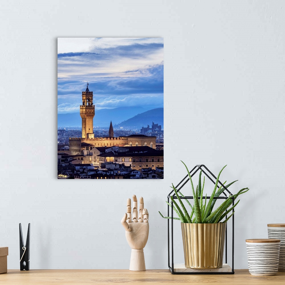 A bohemian room featuring Palazzo Vecchio at dusk, elevated view, Florence, Tuscany, Italy.