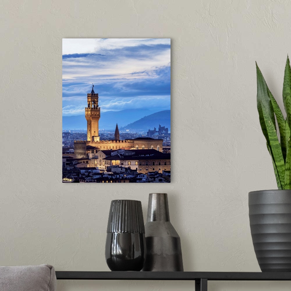 A modern room featuring Palazzo Vecchio at dusk, elevated view, Florence, Tuscany, Italy.