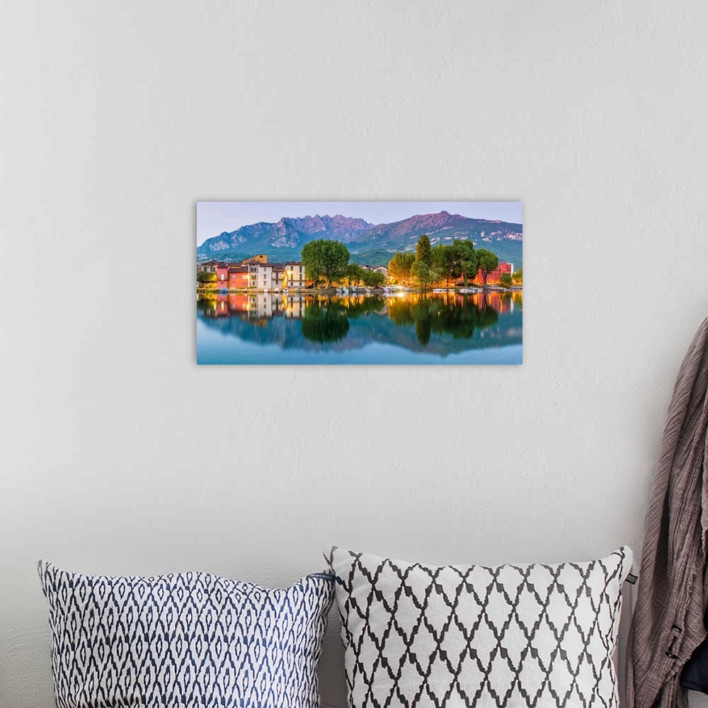 A bohemian room featuring Lecco, Lombardy, Italy. Panoramic view of the colorful houses and the Mount Resegone reflected on...