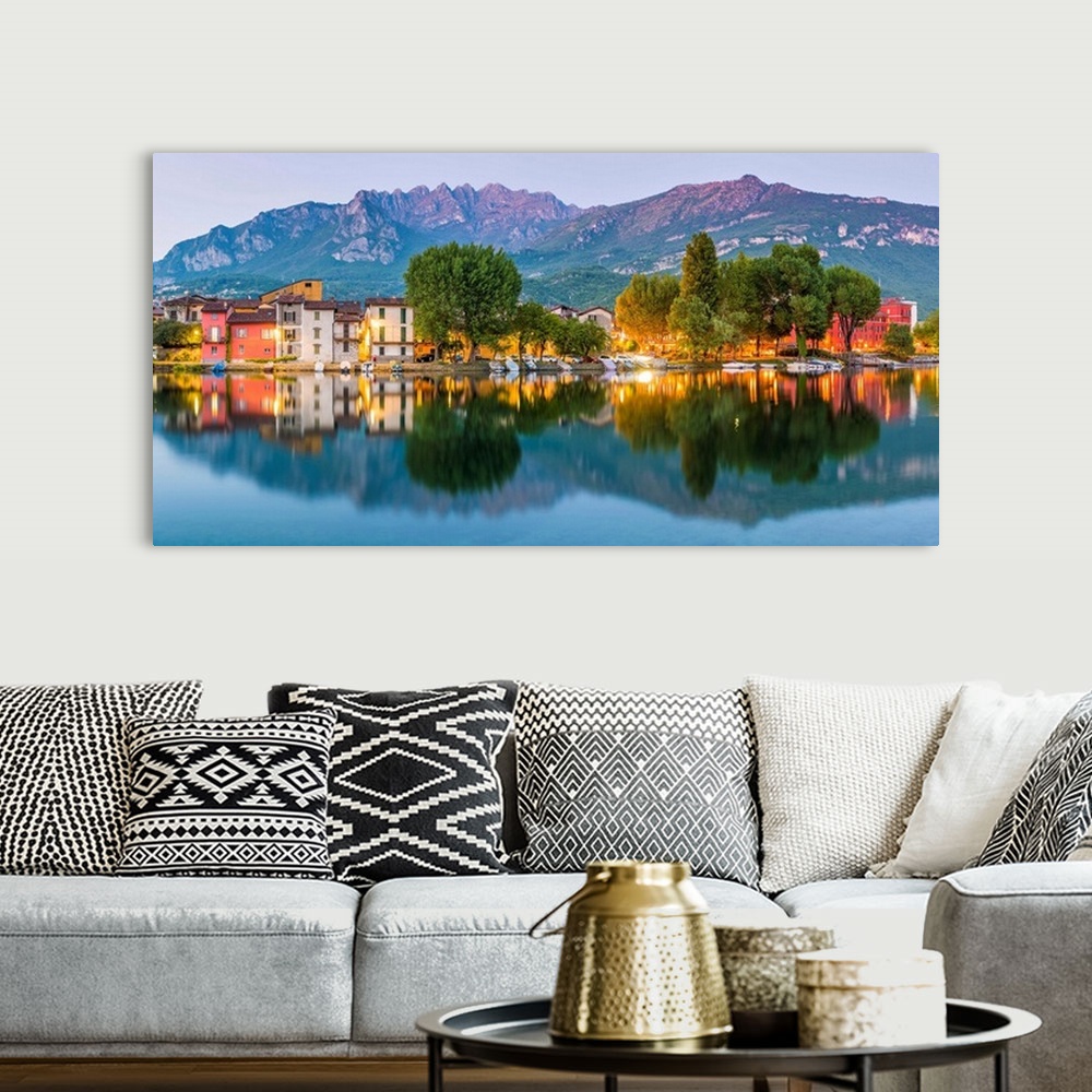 A bohemian room featuring Lecco, Lombardy, Italy. Panoramic view of the colorful houses and the Mount Resegone reflected on...