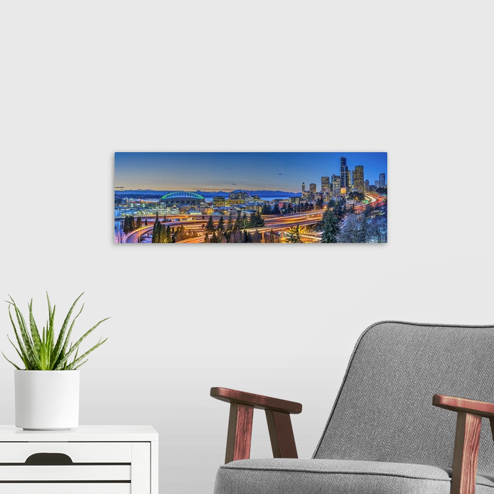 A modern room featuring Panoramic view over Downtown skyline with Interstate 5 at twilight, Seattle, Washington, USA.