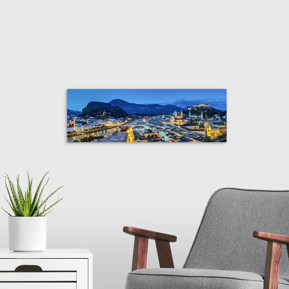 A modern room featuring Panoramic view over the old town and Hohensalzburg Castle at dusk, Salzburg, Austria