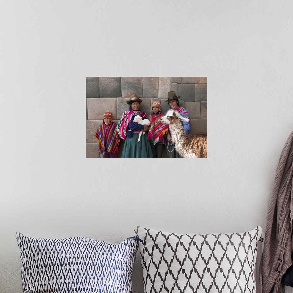 A bohemian room featuring South America, Peru, Cusco. Quechua people standing in front of an Inca wall, holding a lamb and ...