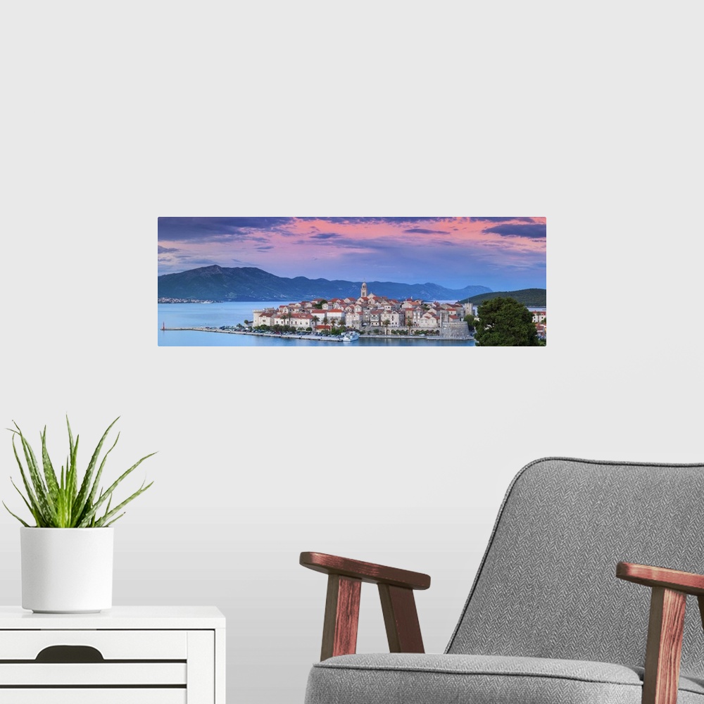 A modern room featuring Elevated view over picturesque Korcula Town illuminated at sunset, Korcula, Dalmatia, Croatia