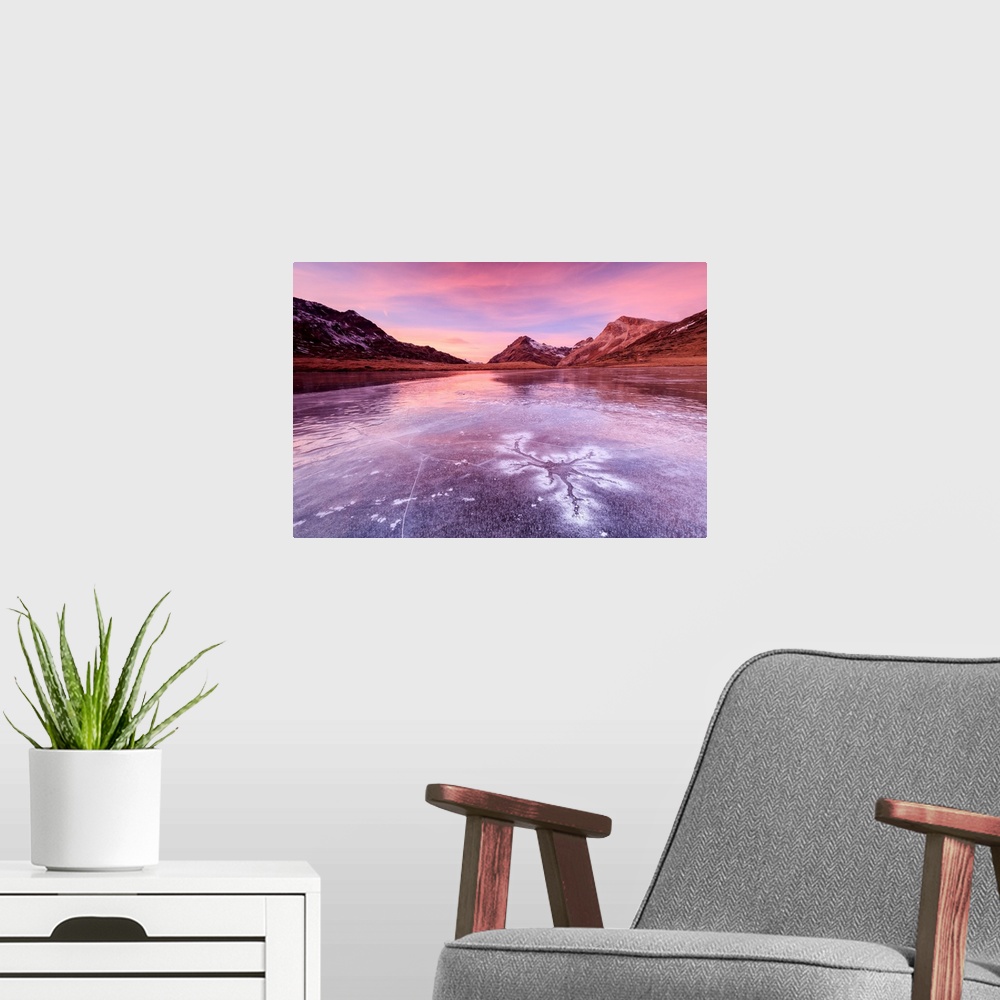 A modern room featuring Pink sky at sunset frames the frozen surface of Lej Nair Bernina Pass Canton of Graubunden Engadi...