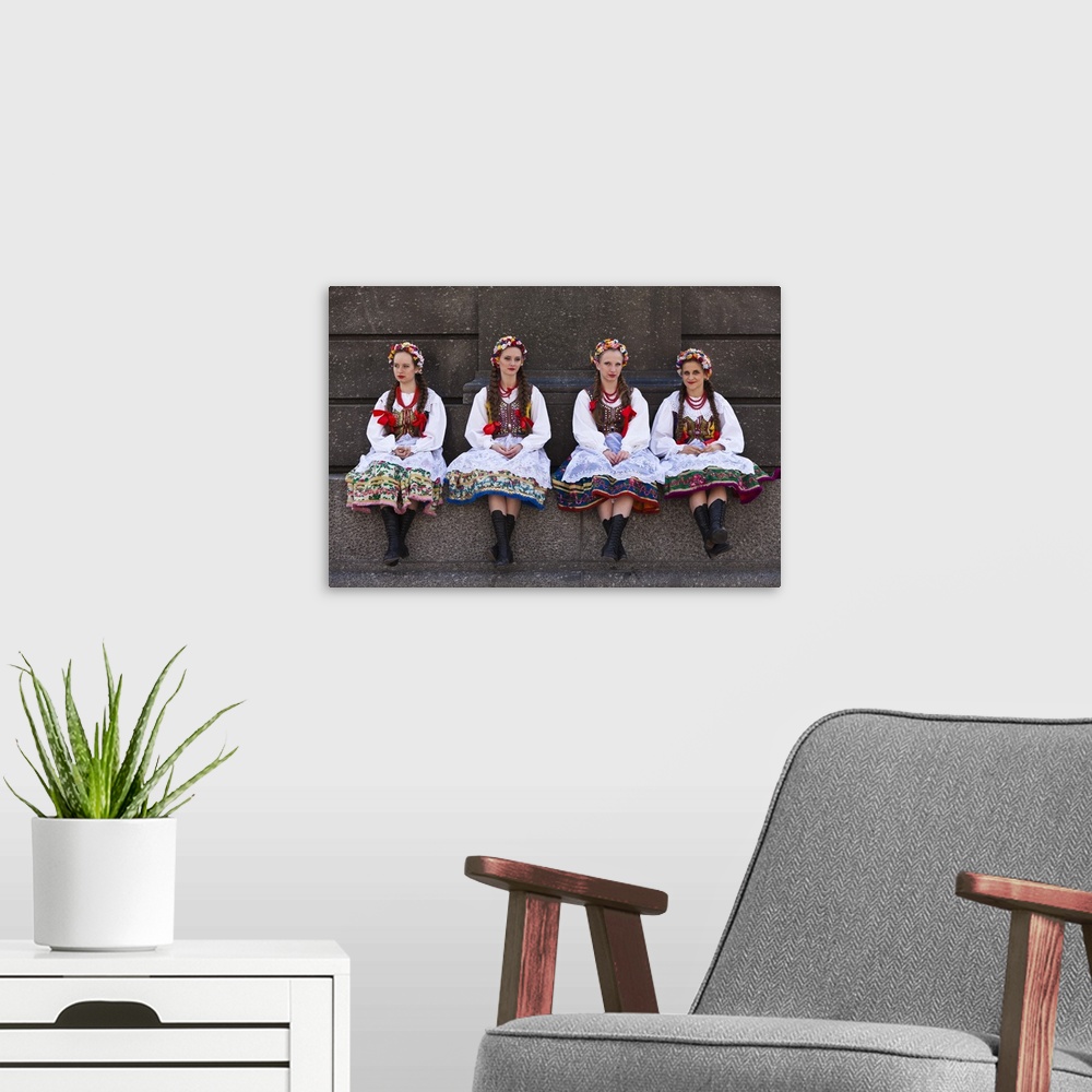 A modern room featuring Poland, Cracow. Polish girls in traditional dress sitting at the base of the statue of Adam Micki...