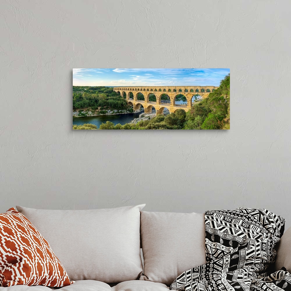 A bohemian room featuring Pont du Gard Roman aqueduct over Gard River in late afternoon, Gard Department, Languedoc-Roussil...