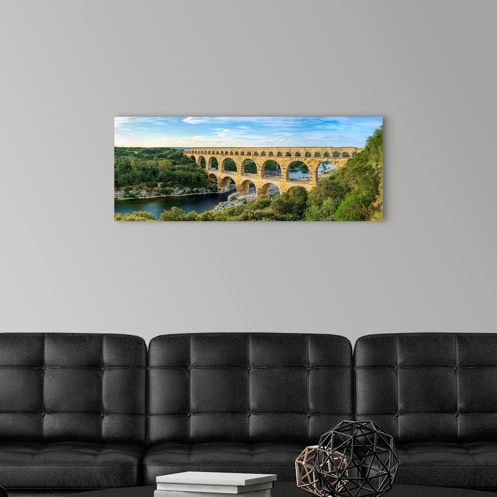 A modern room featuring Pont du Gard Roman aqueduct over Gard River in late afternoon, Gard Department, Languedoc-Roussil...