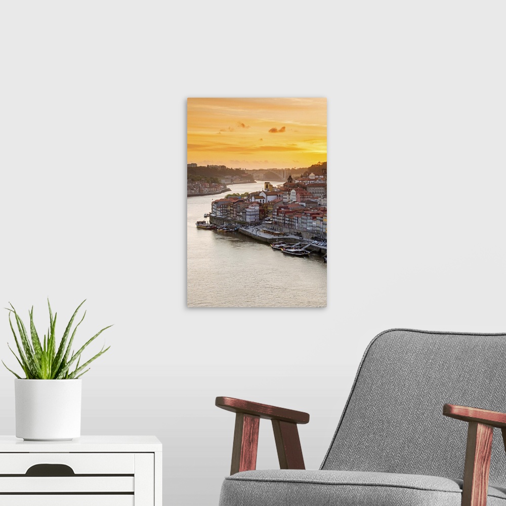 A modern room featuring Portugal, Douro Litoral, Porto. Sunset over the UNESCO listed Ribeira district, viewed from Dom L...