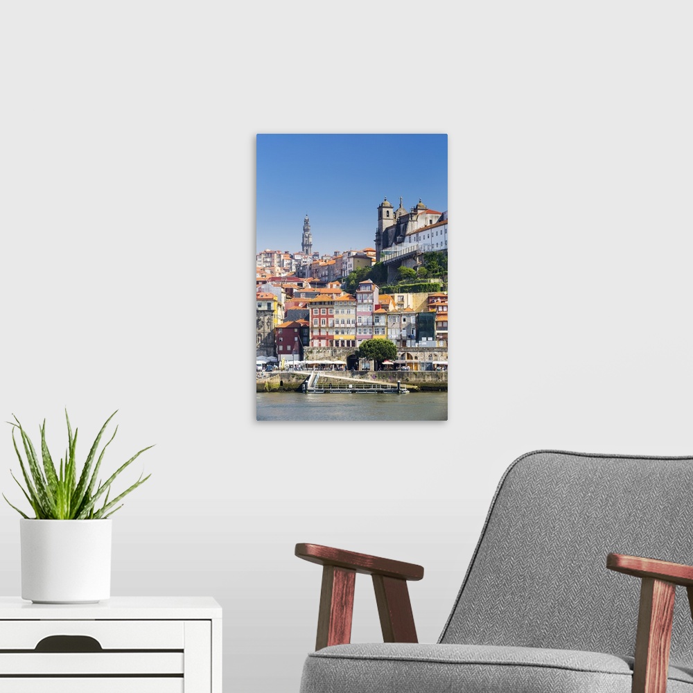 A modern room featuring Portugal, Douro Litoral, Porto. The view across the Douro River to the UNESCO listed Old Town of ...