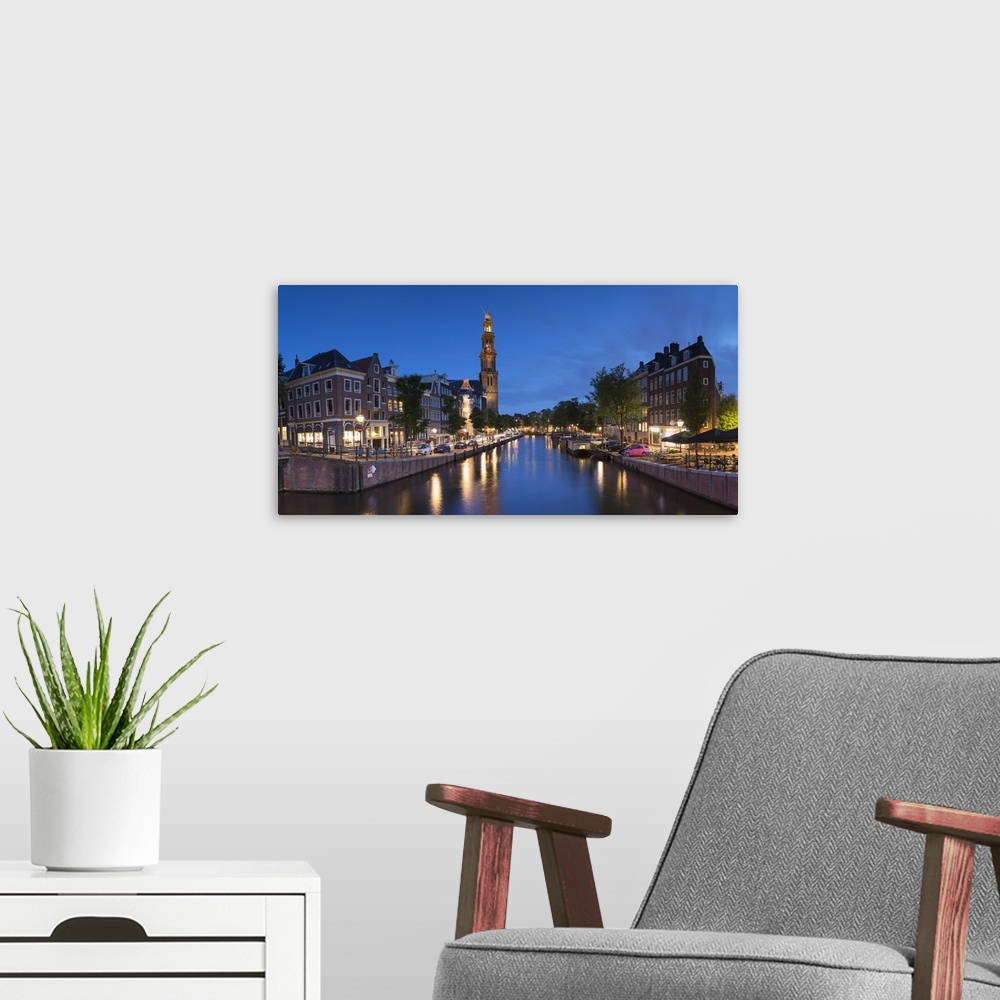 A modern room featuring Prinsengracht canal and Westerkerk at dusk, Amsterdam, Netherlands.