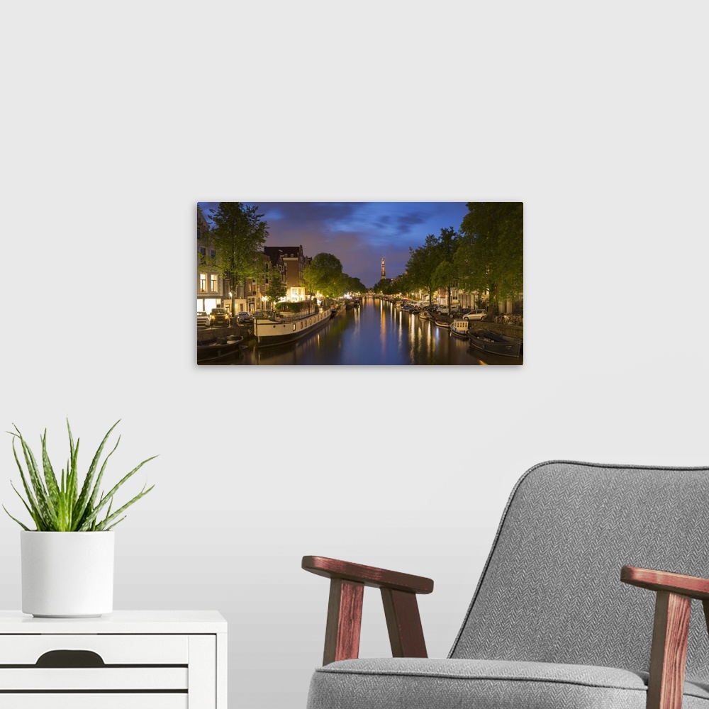 A modern room featuring Prinsengracht canal and Westerkerk at dusk, Amsterdam, Netherlands.