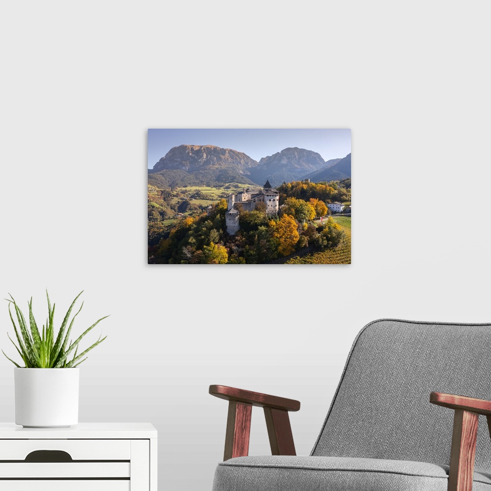 A modern room featuring Prosels Castle (Presule) in autumn. Fie allo Sciliar, Bolzano district, South Tyrol, Dolmites, Tr...