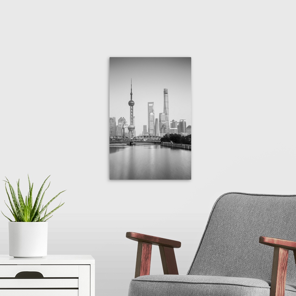 A modern room featuring Pudong skyline across the Suzhou Creek and Waibaidu bridge, Shanghai, China.