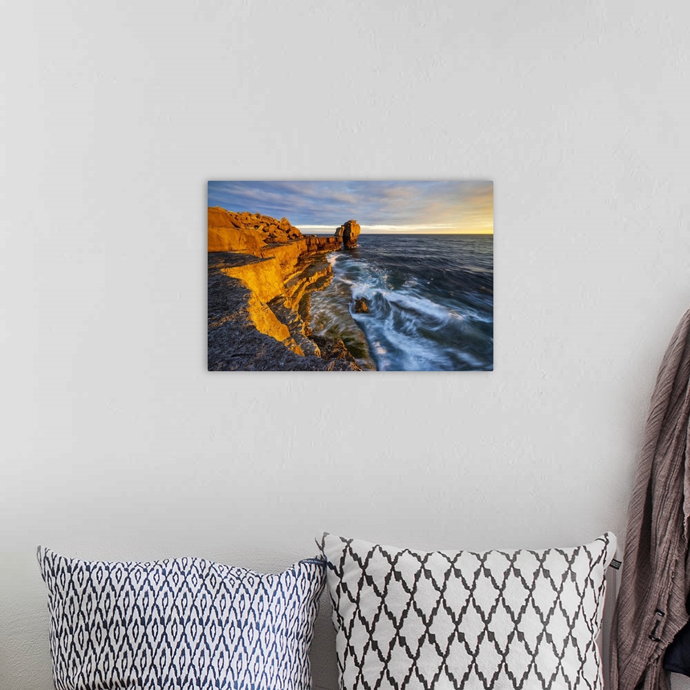 A bohemian room featuring Pulpit rock at Portland Bill during sunset, Isle of Portland, Dorset, United Kingdom.