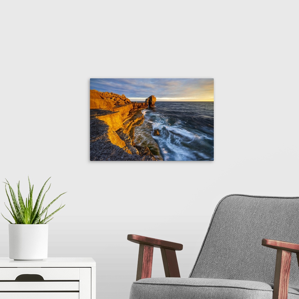 A modern room featuring Pulpit rock at Portland Bill during sunset, Isle of Portland, Dorset, United Kingdom.