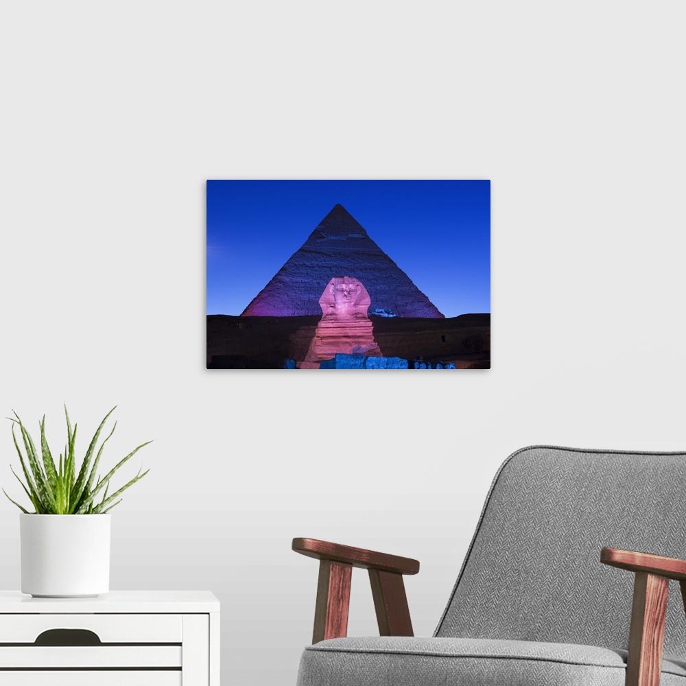 A modern room featuring Pyramid of Khafre (Chephren) and the Sphinx at night, Giza, Cairo, Egypt.