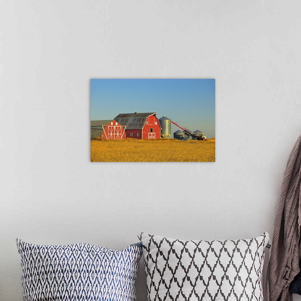 A bohemian room featuring Red Barn, Grain Bins And Auger At Sunrise Near Moose Jaw, Saskatchewan, Canada
