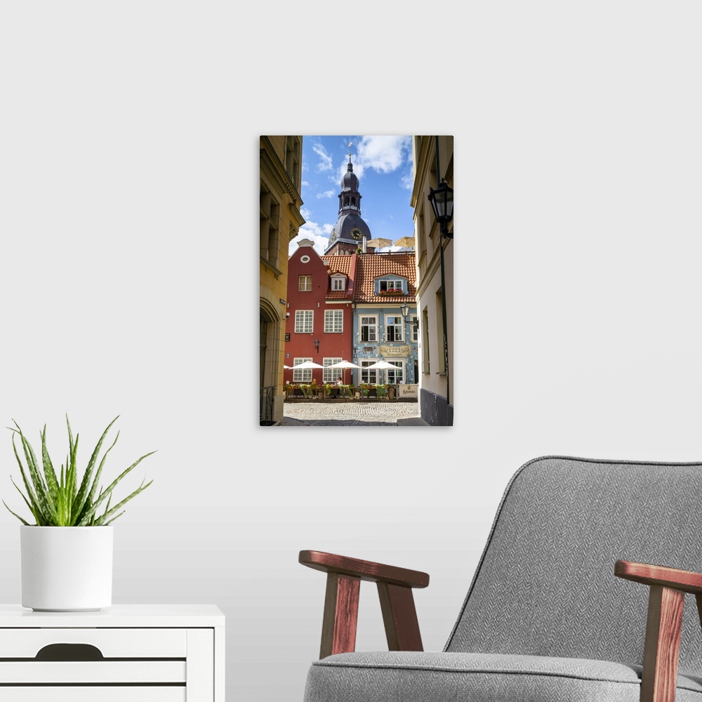 A modern room featuring Restaurant with St Peter's Church, Old Town, Riga, Latvia, Northern Europe,.