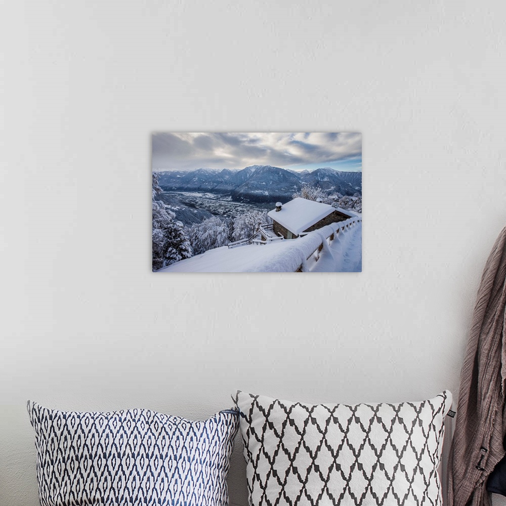 A bohemian room featuring Retiche alps, snowy at Our alp, in the background Valtellina low, Lombardy, Italy.