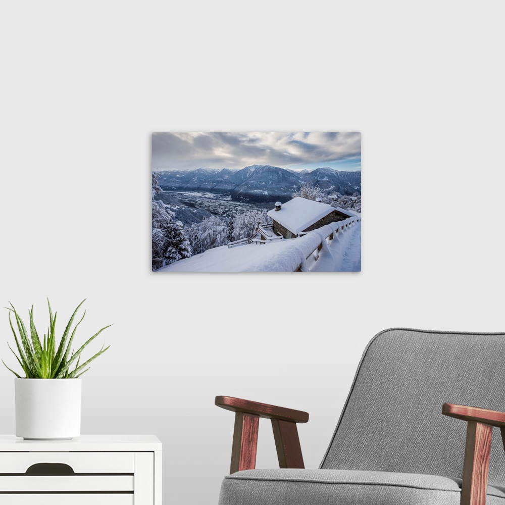 A modern room featuring Retiche alps, snowy at Our alp, in the background Valtellina low, Lombardy, Italy.
