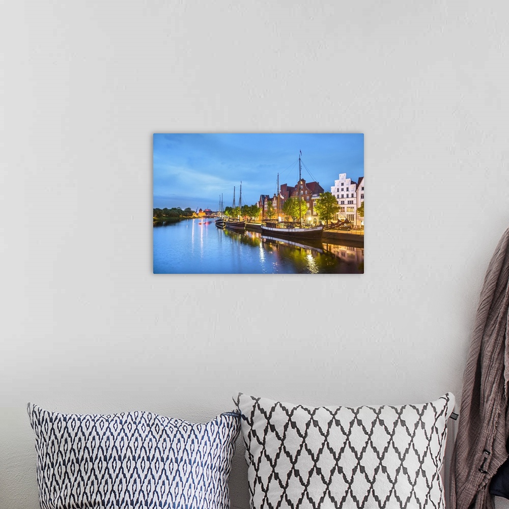 A bohemian room featuring View over river Trave towards old town, Lubeck, Baltic coast, Schleswig-Holstein, Germany.