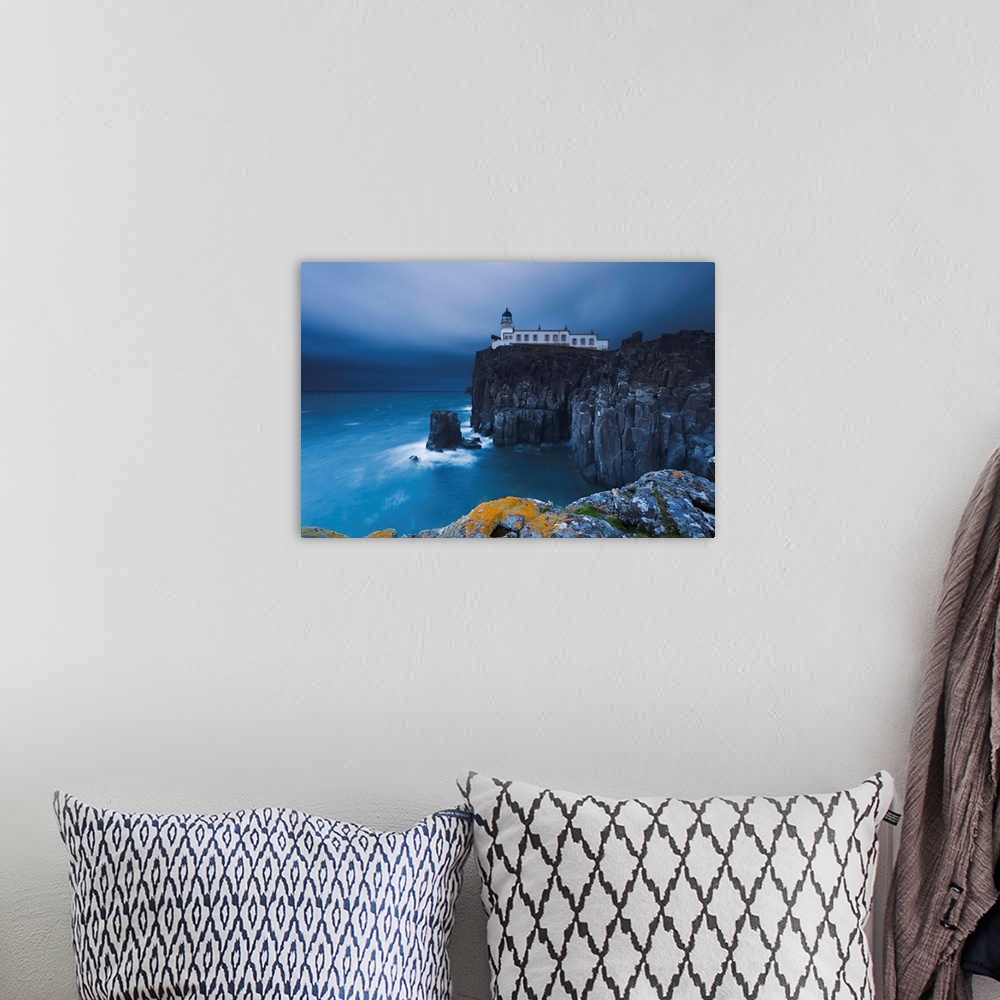 A bohemian room featuring Rocky cliff on the sea, with a lighthouse on the reef, Neist Point, Isle of Skye, Scotland, UK.