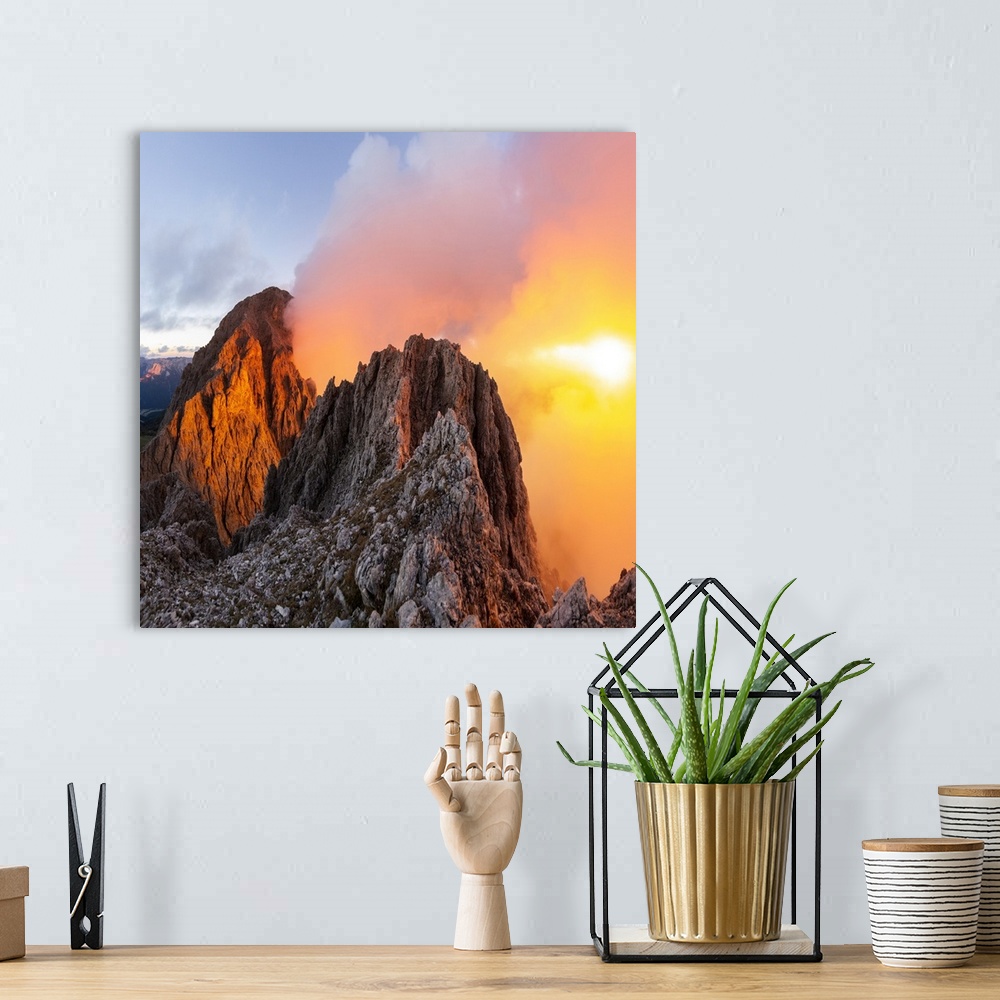A bohemian room featuring Cloudy sunset with Roda de Vael peak illuminated and backlight red clouds from the rocks of Vajol...