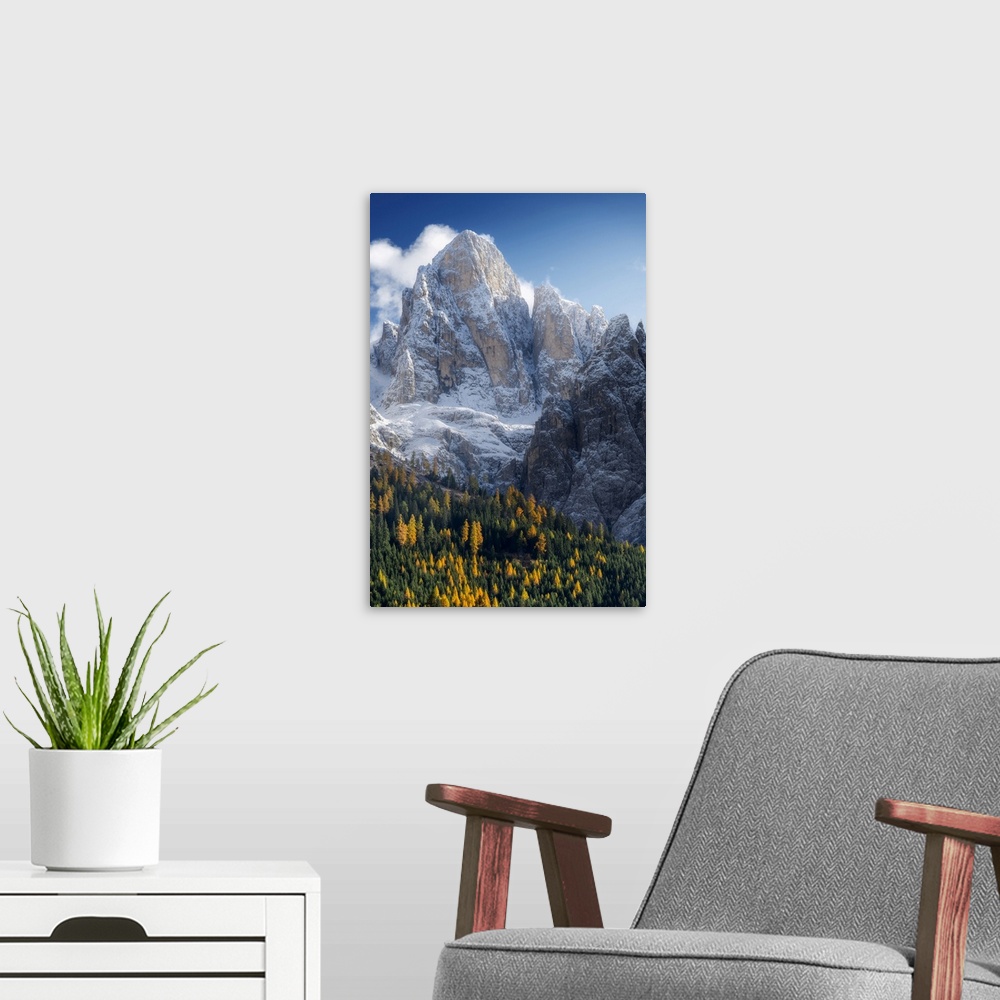 A modern room featuring The first snow of the year in late autumn at Rolle Pass, with the majestic Pale di San Martino in...