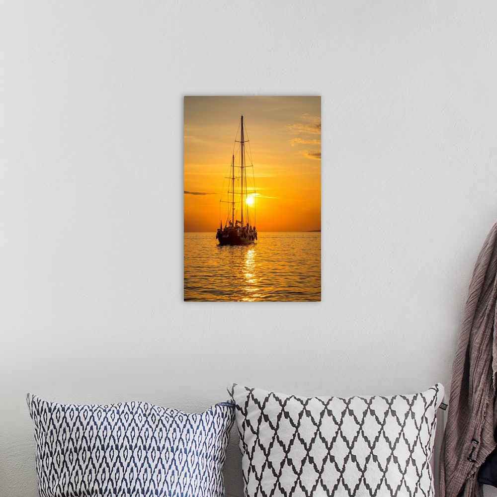 A bohemian room featuring Sailing boat at sunset, Mykonos Town, Mykonos, Cyclade Islands, Greece.
