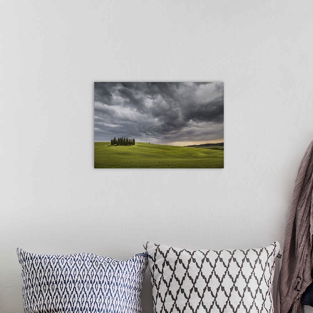A bohemian room featuring San Quirico d'Orcia, Tuscany, Italy. Cypresses and stormy sky.