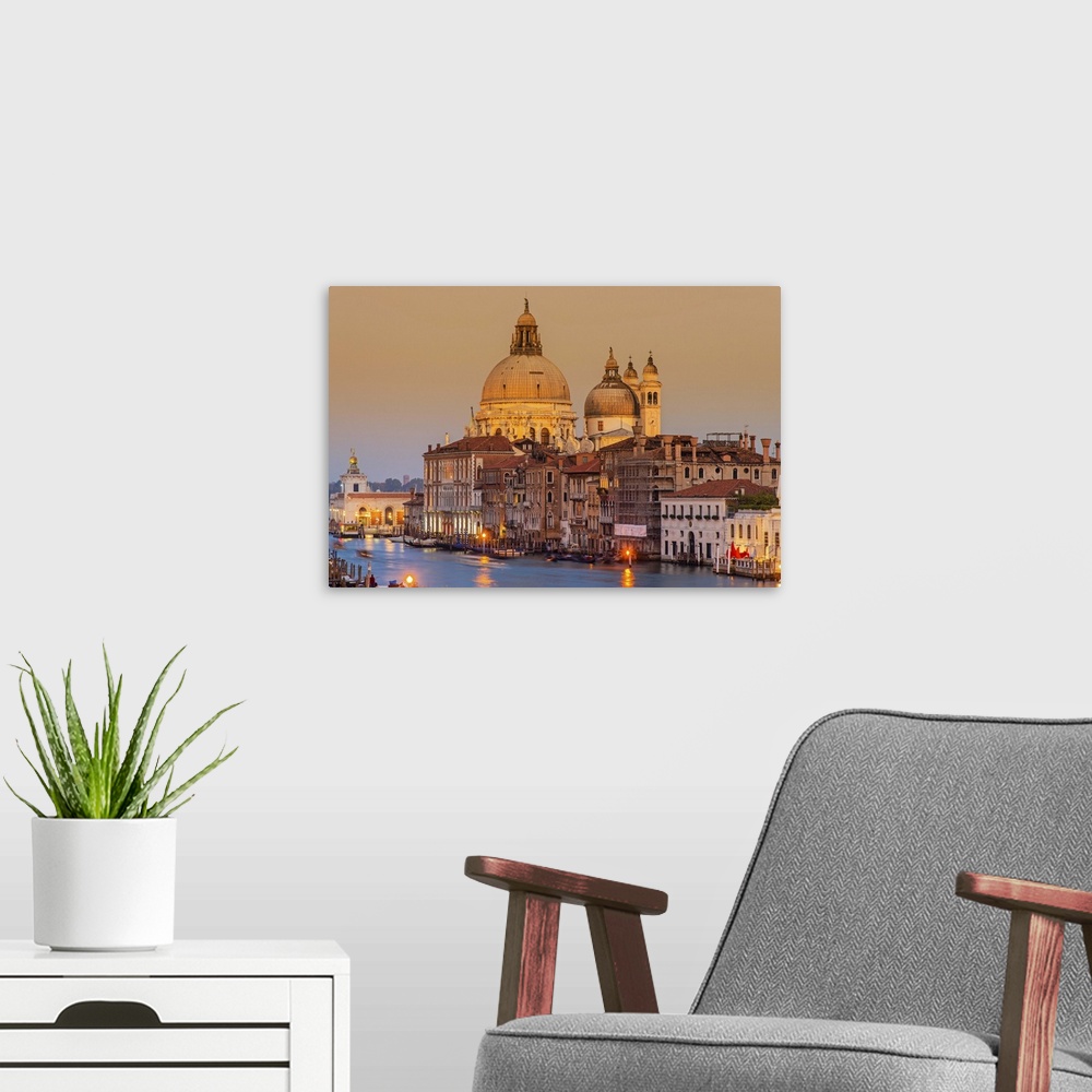 A modern room featuring Santa Maria della Salute church and Grand Canal at sunset, Venice, Veneto, Italy