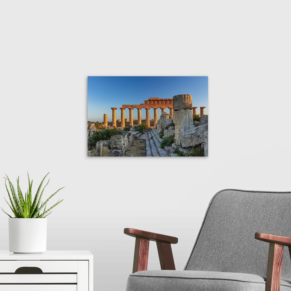 A modern room featuring Selinunte, Sicily. Greek temple at sunset